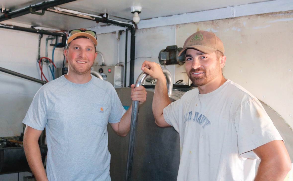 Kevin and Jamieson working together in the dairy plant